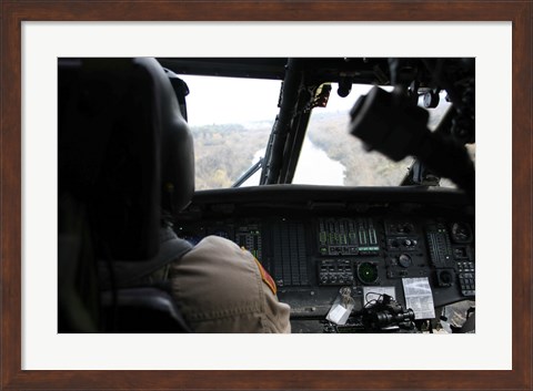 Framed UH-60 Blackhawk flies the River to an Unknown Village to Drop off a Care Package Print