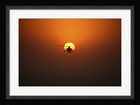 Framed AH-64D Apache Helicopter Flying into the Sun over Iraq Print