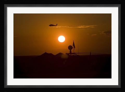 Framed UH-60 Blackhawk Flies Over Camp Speicher Airfield at Sunset Print