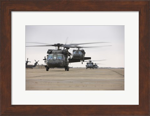 Framed UH-60 Black Hawks taxis out for a mission over northern Iraq Print