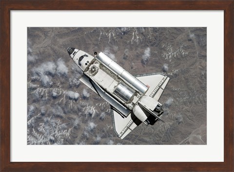 Framed Aerial view of Space Shuttle Discovery over Earth as it approaches the International Space Station Print
