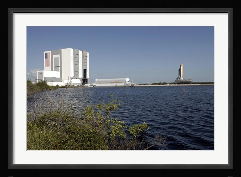 Framed Viewed across the Basin, Space Shuttle Atlantis Crawls Toward the Launch Pad Print