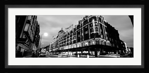 Framed Low angle view of buildings lit up at night, Harrods, London, England BW Print
