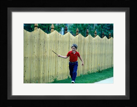 Framed 1980s Smiling Boy Running Along Sidewalk Print
