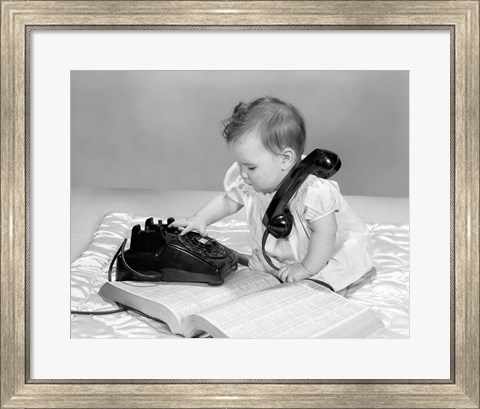 Framed 1960s Baby Girl With Telephone Book Print