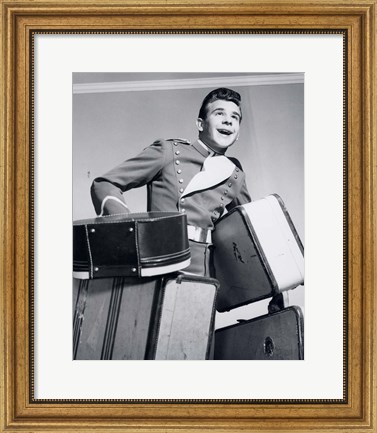 Framed 1950s Smiling Bellboy Carrying Four Bags Of Luggage Print