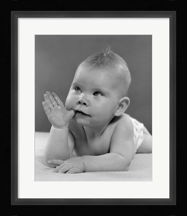 Framed 1950s Baby Lying On Stomach With Thumb In Mouth Print