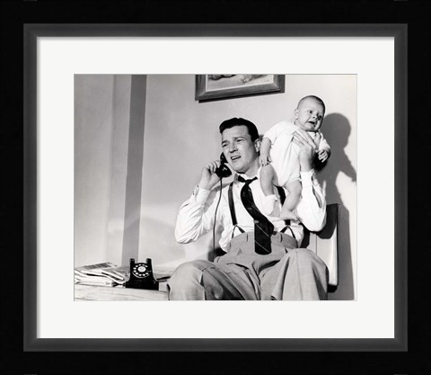 Framed 1950s Father Holding Baby While On The Phone Print