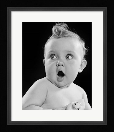 Framed 1950s Wide Eyed Baby Holding Toy Rattle Print