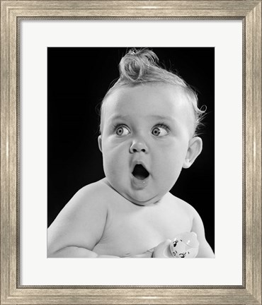Framed 1950s Wide Eyed Baby Holding Toy Rattle Print