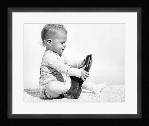 Framed 1960s Baby Boy Trying To Put On Man'S Shoe Print