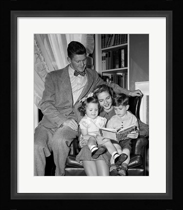 Framed 1940s Father Watching  Mother Reading To Son And Daughter Print